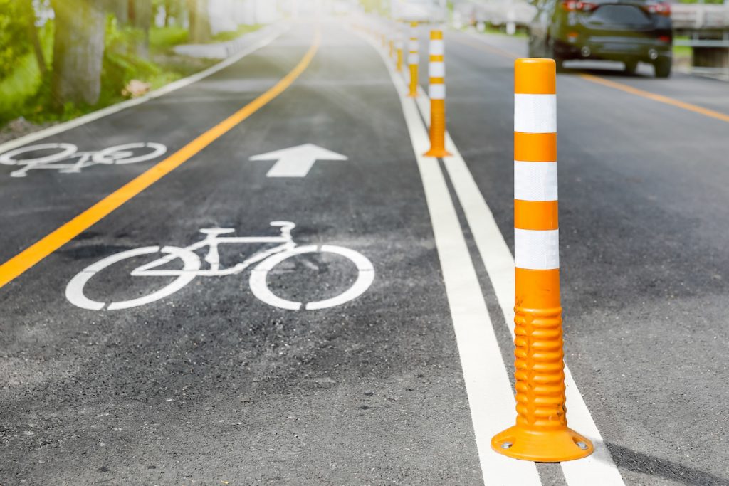 Close-up of a bike lane with orange bollards